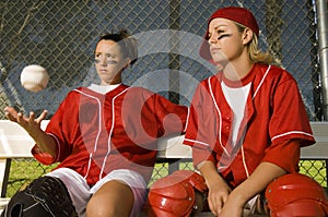 Softball Players Sitting On Bench