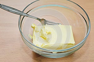 Softened butter in a glass dish, cooking home-made cake