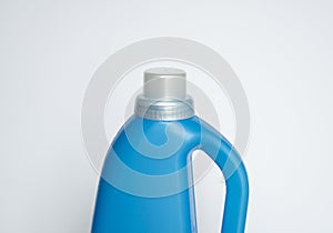 Softener in blue plastic bottle isolated on white background. Bottle with liquid laundry detergent, cleaning agent