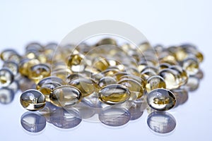 Softgel capsules on reflective surface