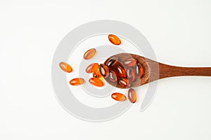 softgel in a spoon, Close up of oil filled capsules, suitable for presenting food supplements : fish oil, omega 3, omega 6, omega