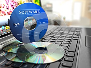 Software CD on laptop keyboard. Compact disks.