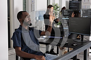 Software developer analysing ar hologram to work on html code