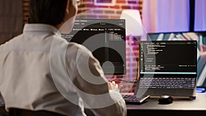 Software developer coding firewall server on computer and laptop