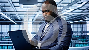 Software developer in data center runs system diagnostic tests on notebook