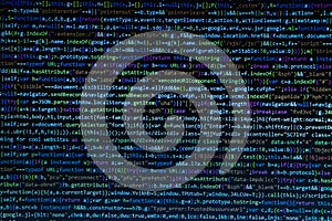 The software developer is doing javascript coding. Abstract code background. Selective focus code on computer screen