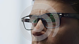 Software developer glasses reflecting terminal code closeup. It man hacker work