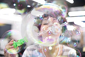 Software developer having fun while making soap bubble