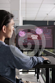 Software developer having web server hacked looking at computer
