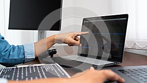 Software developer or programmer working data debugging improvement binary algorithm on desktop pc in a software develop company