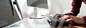 Software developer or programmer working data debugging improvement binary algorithm on desktop pc in a software develop company