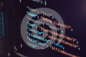 Software developer programming code. Abstract computer script code closeup on monitor screen with bokeh