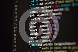 Software developer programming code. Abstract computer script code closeup on monitor screen with bokeh