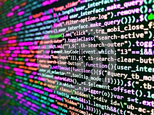 Software developer programming code on computer monitor. Javascript code in bracket software. Shallow Depth of Field effect.