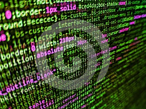 Software developer programming code. HTML CSS3 source code on lcd screen with black background. Software background technology.