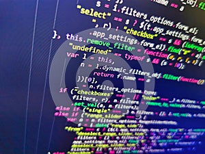 Software developer programming code. Screen of web developing code on dark background. Closeup of Web Code on Computer LED Screen