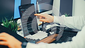 Software developer programming laptop screen code workspace