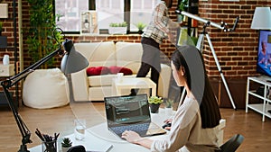 Software developer types programming code in a cozy home office setup