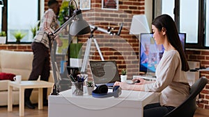 Software developer types programming code in a cozy home office setup