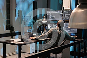 Software developer typing programming code on computer