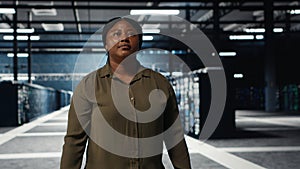 Software developer walking in data center, checking hardware