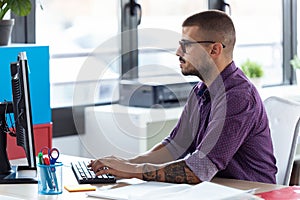 Software developer working with computer in the modern startup office