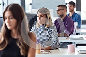 Software developer working with computer in the modern startup office