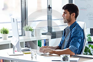 Software developer working with computer in the modern startup office