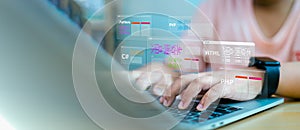 Software Developer working on laptop with virtual coding language screens