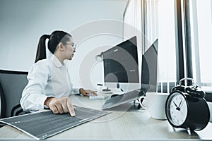 Software developers are analyzing about the code written into the program on the computer in office room