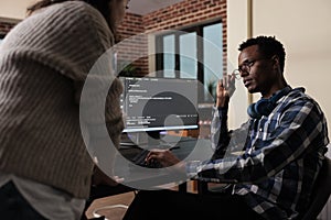 Software developers sitting at desk and developing a functional data encryption system.