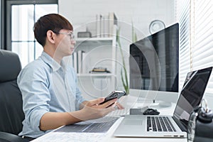 Software development concept, Male programmer check website programming on smartphone and computer