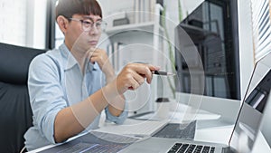 Software development concept, Male programmer pointing on laptop screen to checking data codes