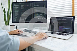 Software development concept, Male programmer typing data code on laptop to develop app and website