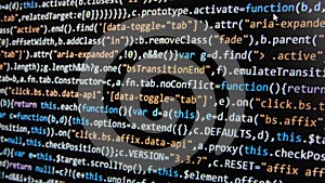 Software development. Programmer coding on the computer monitor. Close-up. Computer program code on a black background.