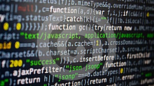 Software development. Programmer coding on the computer monitor. Close-up. Computer program code on a black background.