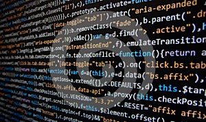 Software development. Programmer coding on the computer monitor. Close-up. Computer program code on a black background.