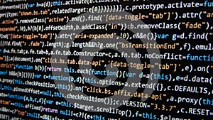 Software development. Programmer coding on the computer monitor. Close-up. Computer program code on a black background.