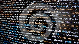 Software development. Programmer coding on the computer monitor. Close-up.