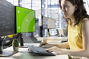 Software engineer checking code on chroma key PC