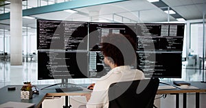 Software Engineer Debugging Code At Desk