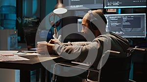 Software engineer using terminal window on laptop to program new code