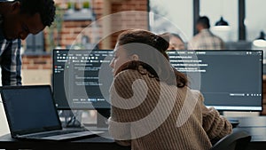 Software programer putting laptop with source code on colleague coder desk asking for opinion