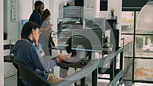 Software programer typing source code on computer keyboard