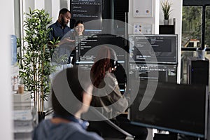 Software programmers discussing about algorithms on big screen