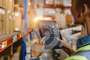 Software Smart warehouse management in tablet computer real time monitoring track goods package delivery. Inventory worker showing