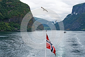 Sognefjord and Neroyfjord mountain sea view with Norwegian flag, Norway