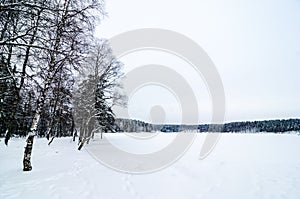 Sognsvann lake in Oslo, Norway, frozen a covered with snow photo