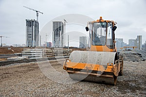 Soil Compactor at construction site. Vibration single-cylinder road roller for leveling soil, gravel, concrete, or asphalt