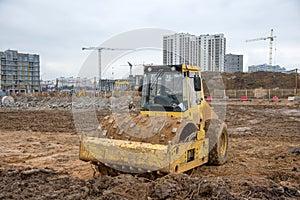 Soil Compactor at construction site. Vibration single-cylinder road roller for leveling soil, gravel, concrete, or asphalt in the